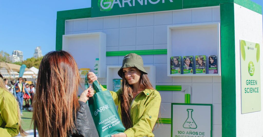 Garnier event with women distributing branded bags at an outdoor stall.